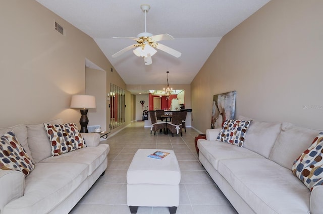 tiled living room with ceiling fan with notable chandelier and vaulted ceiling