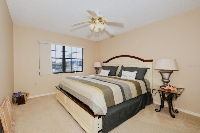 carpeted bedroom featuring a textured ceiling and ceiling fan