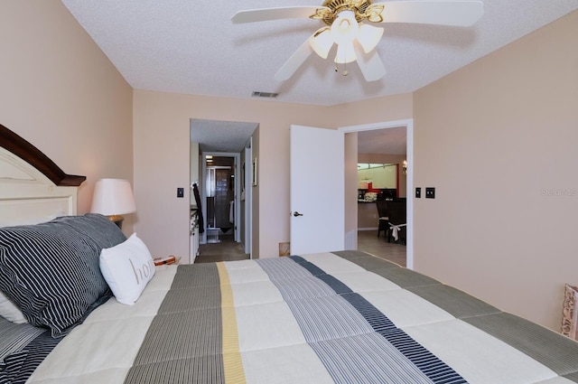 bedroom featuring ceiling fan and a textured ceiling