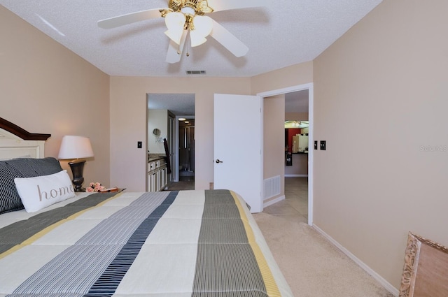 carpeted bedroom featuring a textured ceiling, white fridge, and ceiling fan