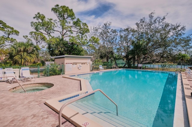 view of pool with a hot tub