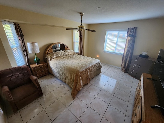 tiled bedroom with ceiling fan