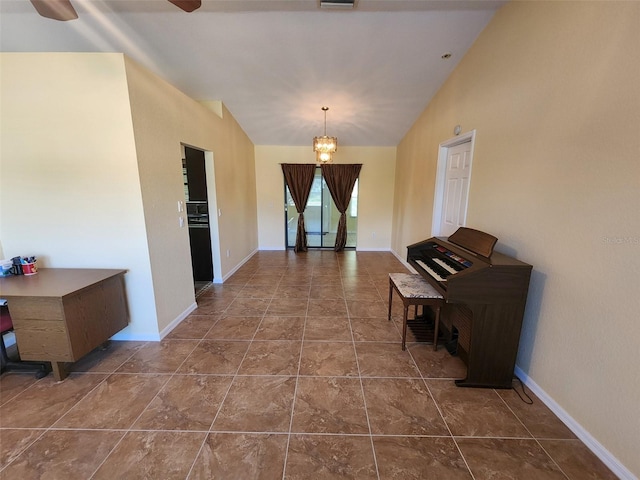 hall featuring an inviting chandelier and lofted ceiling