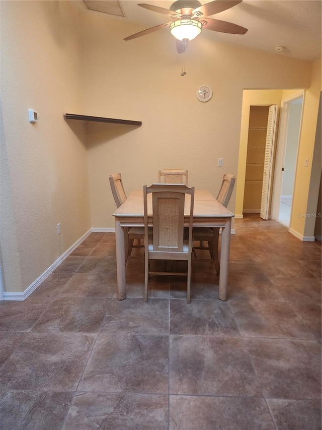 dining room featuring ceiling fan and lofted ceiling