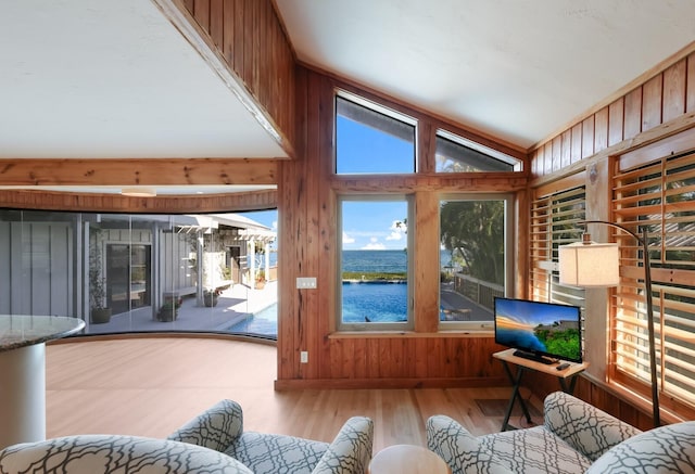 sunroom / solarium featuring vaulted ceiling