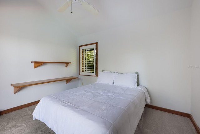 carpeted bedroom with ceiling fan and lofted ceiling