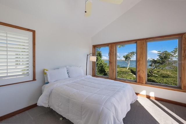 bedroom with ceiling fan, a water view, carpet floors, and high vaulted ceiling