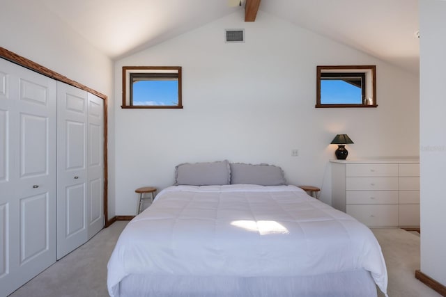 bedroom featuring light carpet, lofted ceiling with beams, and a closet