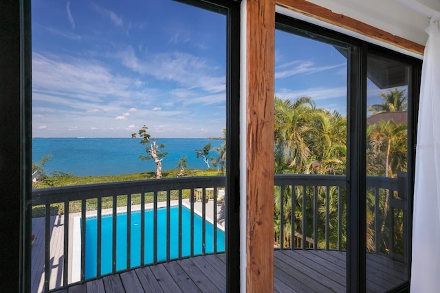 doorway to outside featuring hardwood / wood-style floors and a water view