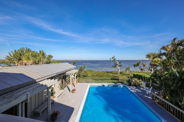 view of swimming pool featuring a water view