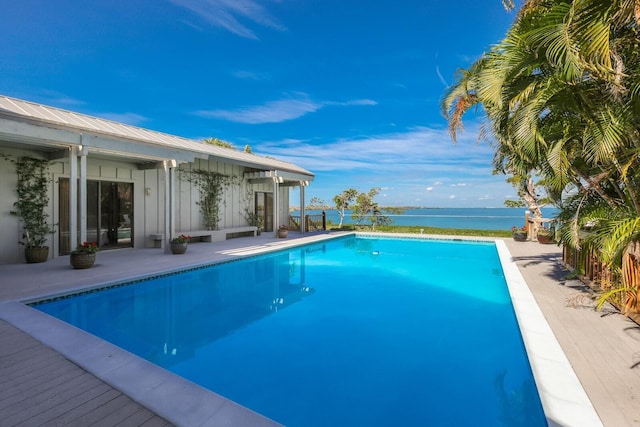 view of swimming pool with a water view