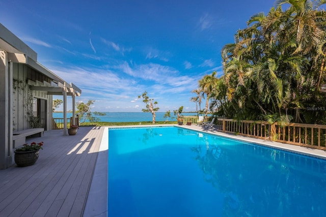 view of swimming pool featuring a deck with water view