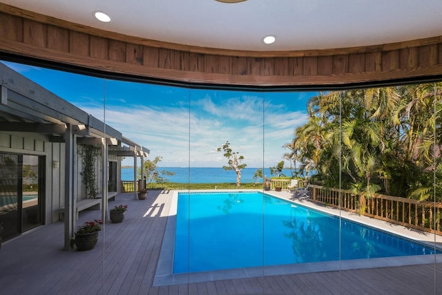 view of pool featuring a deck with water view