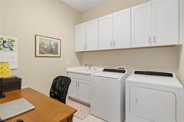 washroom featuring cabinets, washer and clothes dryer, and sink