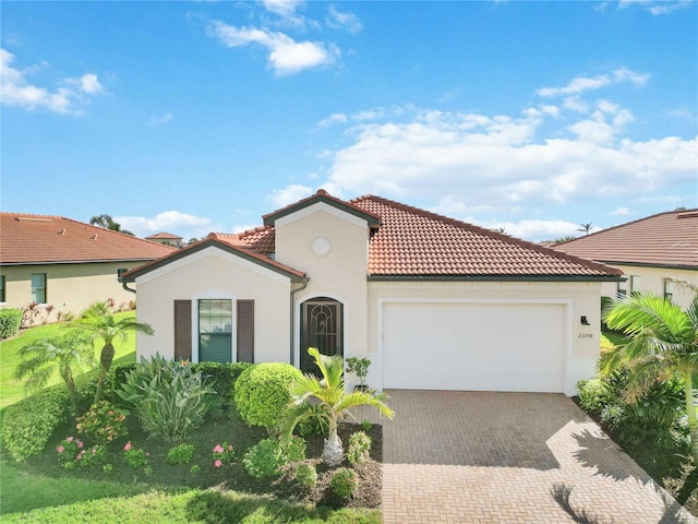 mediterranean / spanish-style home with a garage