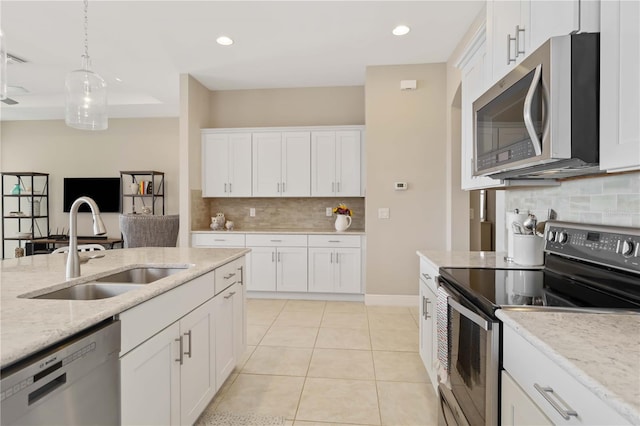 kitchen with white cabinets, appliances with stainless steel finishes, and sink