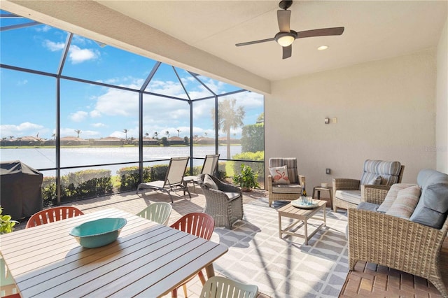 view of patio / terrace with a water view, an outdoor hangout area, a grill, ceiling fan, and a lanai