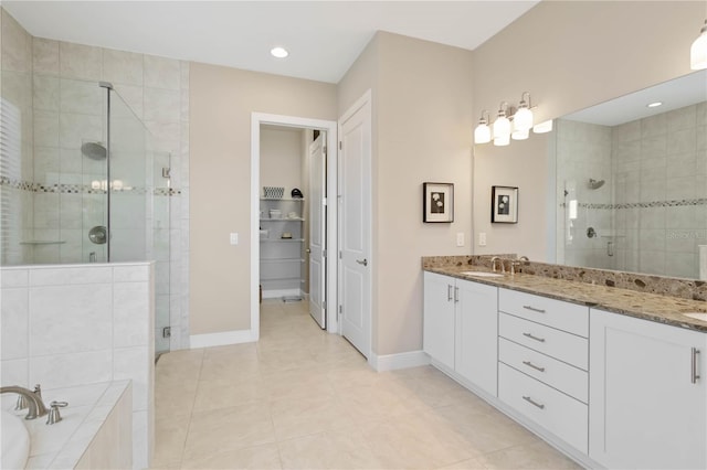 bathroom featuring shower with separate bathtub, tile patterned flooring, and vanity