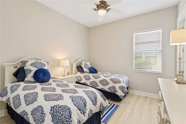 bedroom with ceiling fan and light hardwood / wood-style floors