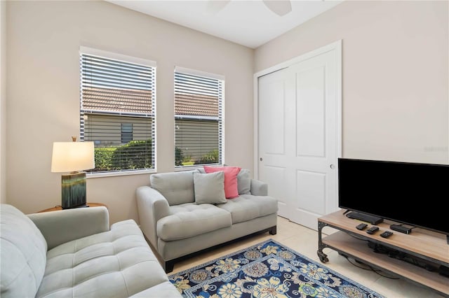 tiled living room featuring a healthy amount of sunlight and ceiling fan