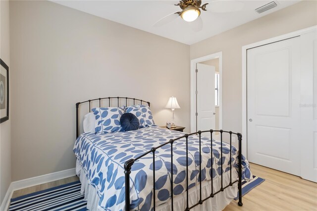 bedroom with hardwood / wood-style floors and ceiling fan