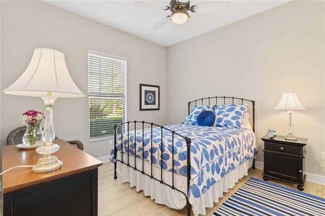 bedroom with ceiling fan and light wood-type flooring