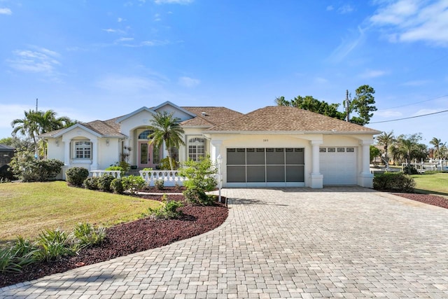 single story home featuring a garage and a front lawn