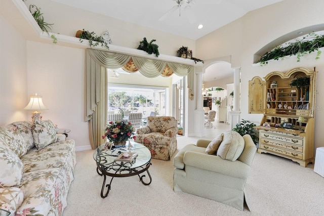 living room with decorative columns, carpet, lofted ceiling, and ceiling fan