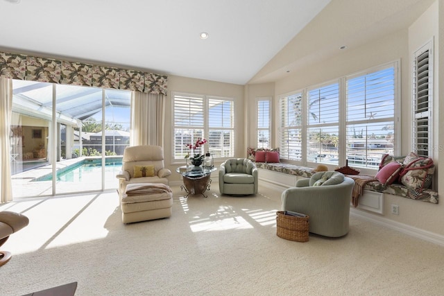 sunroom featuring lofted ceiling and plenty of natural light