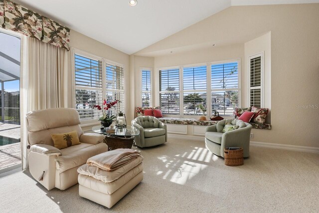 living area featuring lofted ceiling and carpet flooring