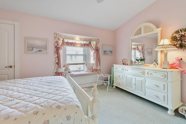 bedroom with vaulted ceiling and light carpet