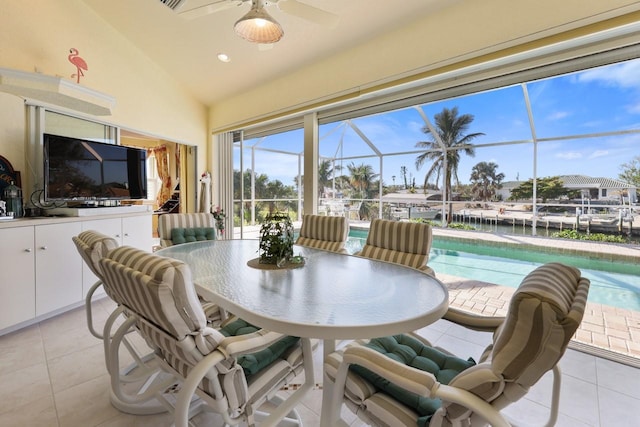 sunroom / solarium with vaulted ceiling, ceiling fan, and a water view