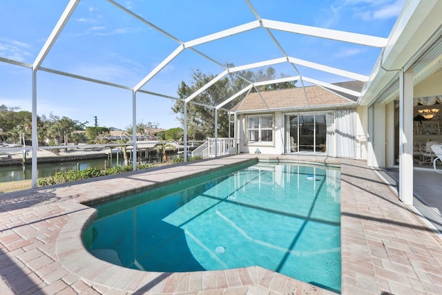 view of swimming pool featuring a lanai, a patio, and a water view