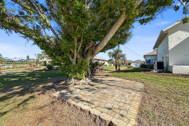 view of yard with ac unit and a patio area