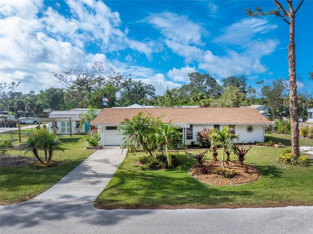 single story home featuring a front lawn and a garage