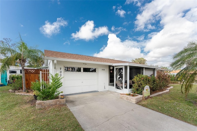 single story home featuring a garage and a front yard