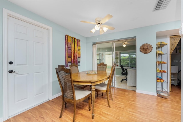 dining area featuring light wood-type flooring and ceiling fan