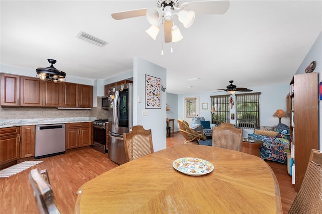 dining room featuring ceiling fan and light wood-type flooring