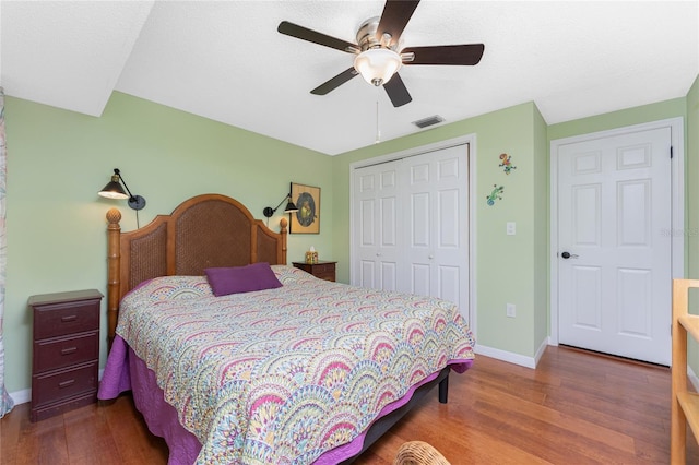 bedroom with a closet, ceiling fan, and hardwood / wood-style flooring