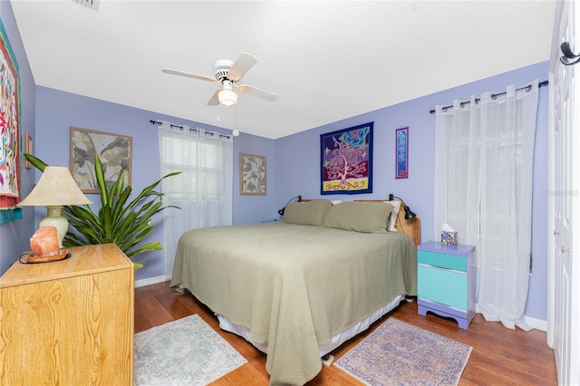 bedroom featuring ceiling fan and dark hardwood / wood-style floors