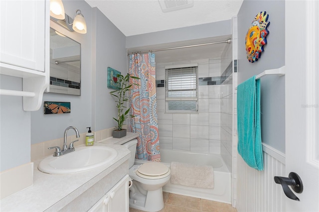 full bathroom with tile patterned floors, vanity, toilet, and shower / tub combo