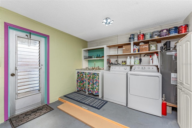 washroom featuring washer and clothes dryer, electric water heater, and a textured ceiling