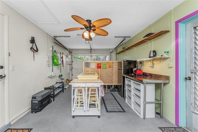 kitchen featuring a textured ceiling, ceiling fan, and green cabinets