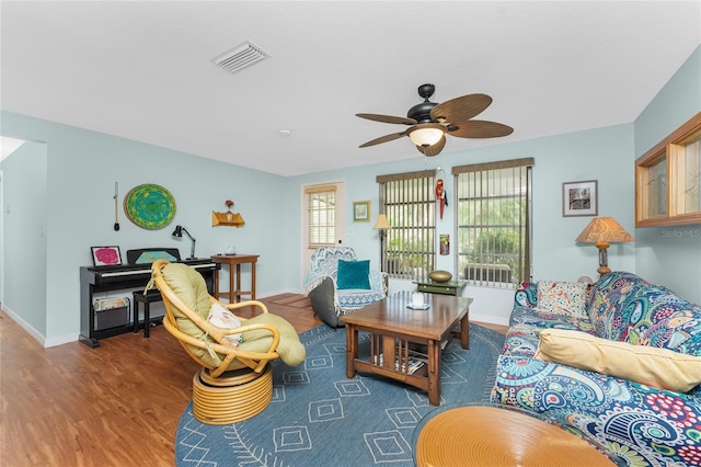 living room featuring ceiling fan and hardwood / wood-style floors