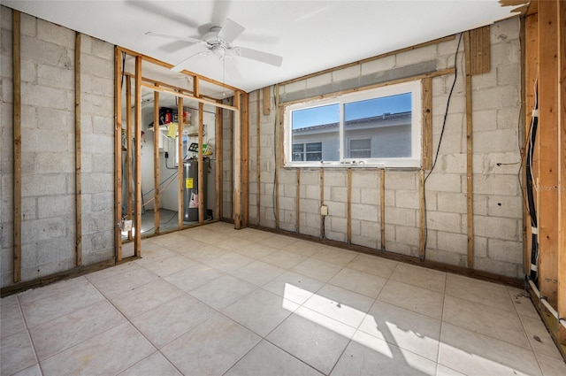 basement with ceiling fan and water heater