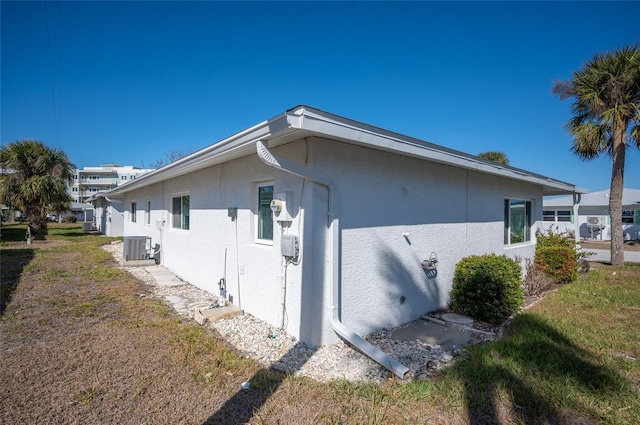 view of side of home featuring central AC unit