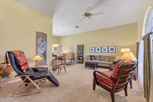 carpeted living room featuring ceiling fan