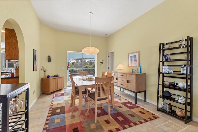 dining area with a towering ceiling