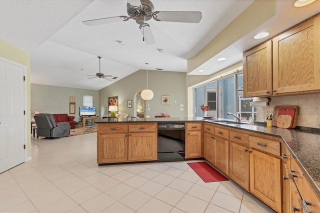 kitchen featuring dishwasher, sink, vaulted ceiling, light tile patterned floors, and kitchen peninsula