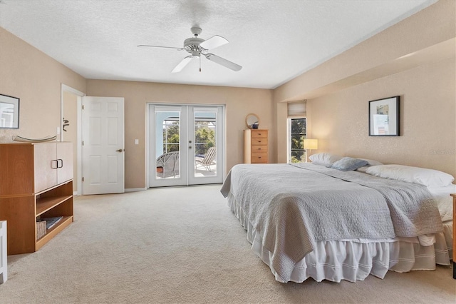 carpeted bedroom featuring access to exterior, ceiling fan, french doors, and a textured ceiling